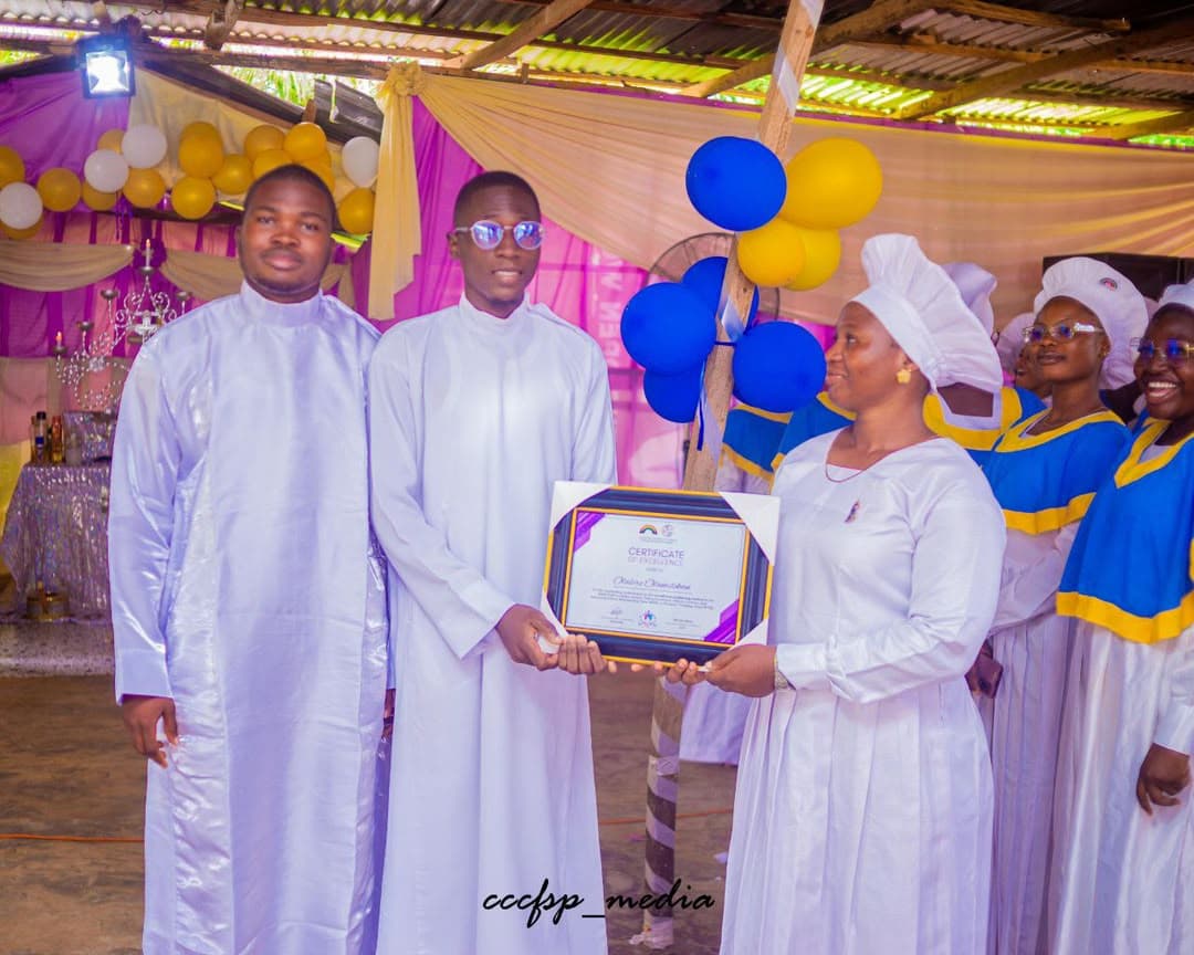 A graduate presenting a framed certificate