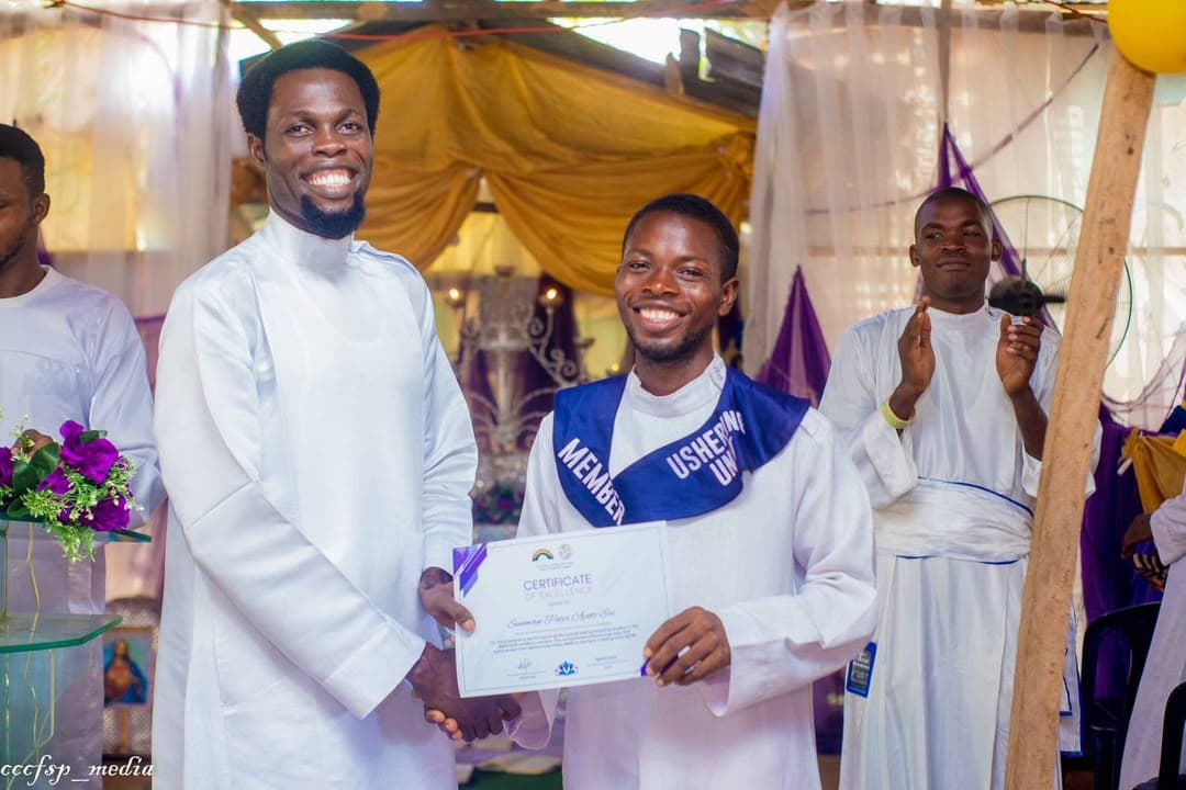 A Discipleship College graduate receiving a certificate